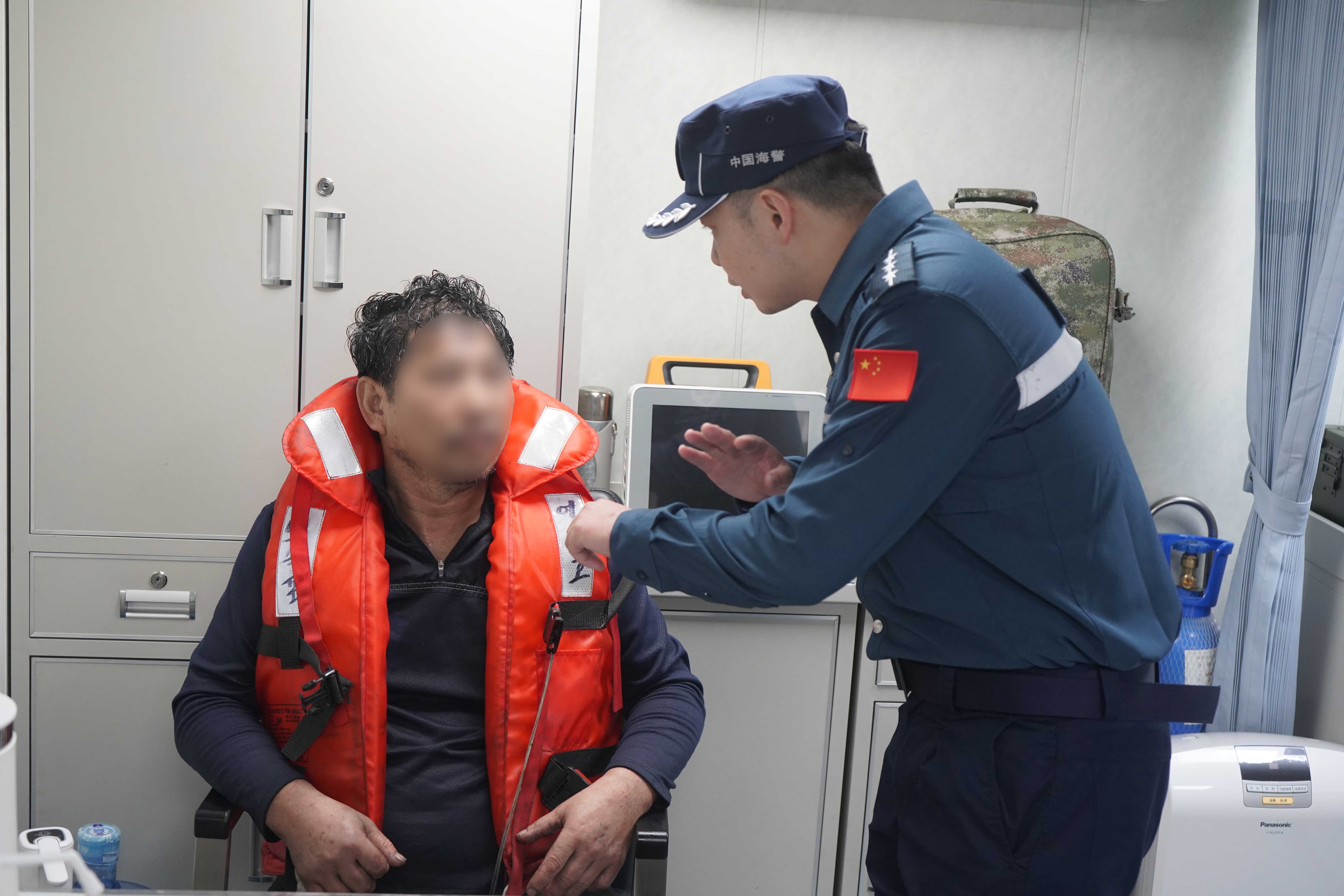 △中国海警执法员对遇险渔民身体状况进行检查.jpg